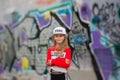 Little girl in a tracksuit dancing modern dance in the street in the background color of the wall. Young urban hip hop dancer Royalty Free Stock Photo