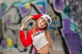 Little girl in a tracksuit dancing modern dance in the street in the background color of the wall. Young urban hip hop dancer Royalty Free Stock Photo