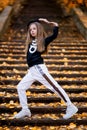 Little girl in a tracksuit is dancing modern dance on the street. Girl dancing Vogue Royalty Free Stock Photo