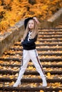 Little girl in a tracksuit is dancing modern dance on the street. Girl dancing Vogue Royalty Free Stock Photo