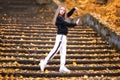 Little girl in a tracksuit is dancing modern dance on the street. Girl dancing Vogue Royalty Free Stock Photo