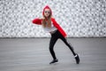 Little girl in a tracksuit is dancing modern dance on the street. Young urban hip hop dancer Royalty Free Stock Photo