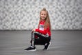 Little girl in a tracksuit is dancing modern dance on the street. Young urban hip hop dancer Royalty Free Stock Photo