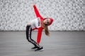 Little girl in a tracksuit is dancing modern dance on the street. Young urban hip hop dancer Royalty Free Stock Photo