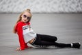 Little girl in a tracksuit is dancing modern dance on the street. Young urban hip hop dancer Royalty Free Stock Photo