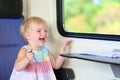 Little girl traveling by train