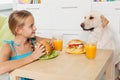 Little girl treating her furry friend with a snack