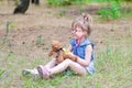 A little girl treats her teddy bear in a forest glade a copy of Royalty Free Stock Photo