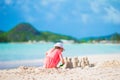 Little adorable girl at tropical beach making sand castle Royalty Free Stock Photo