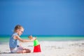 Little girl at tropical white beach making sand castle Royalty Free Stock Photo