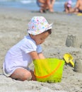 Little girl at tropical beach making sand castle in summer Royalty Free Stock Photo