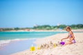 Little girl at tropical white beach making sand castle Royalty Free Stock Photo