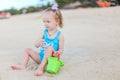 Little girl at tropical white beach making sand castle Royalty Free Stock Photo