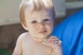 A little girl is trying to taste snacks. Royalty Free Stock Photo