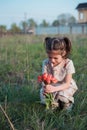 A little girl with tulips in her hands cried. Tears on the face of the child. Children emotions