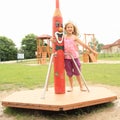 Little girl twisting on a merry-go-round Royalty Free Stock Photo