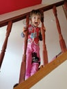 Little girl by two years old with blue eyes and yellow hair, playing on the stairs Royalty Free Stock Photo