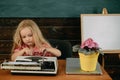 Little girl type research result on typewriter. Child typewrite research work in classroom