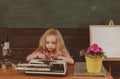 Little girl type on retro typewriter archaism in school. Future and archaism, vintage filter Royalty Free Stock Photo