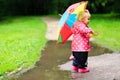 Little girl with umbrella in raincoat and boots Royalty Free Stock Photo