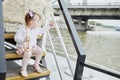 Little girl with umbrella sits on step at pleasure Royalty Free Stock Photo