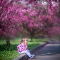 Little girl under blooming crabapple