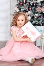 Little girl under the Christmas tree unpacking presents Royalty Free Stock Photo