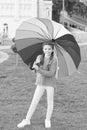 Little girl under umbrella. Rainbow after rain. Optimist and cheerful. Spring style. Positive mood in autumn rainy Royalty Free Stock Photo