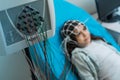 Little girl undergoing electroencephalography procedure