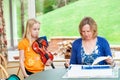 Little girl unhappy with her mother and pushing out her lower lip during violin practice