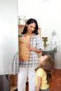 Little girl unpacking grocery bag with her mother Royalty Free Stock Photo