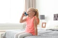 Little girl using asthma inhaler Royalty Free Stock Photo