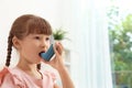 Little girl using asthma inhaler Royalty Free Stock Photo