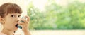 Little girl using asthma inhaler on background, space for text. Banner design Royalty Free Stock Photo