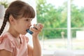 Little girl using asthma inhaler Royalty Free Stock Photo