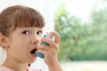 Little girl using asthma inhaler Royalty Free Stock Photo