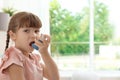 Little girl using asthma inhaler Royalty Free Stock Photo