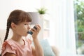 Little girl using asthma inhaler Royalty Free Stock Photo