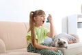 Little girl using asthma inhaler near cat at home Royalty Free Stock Photo