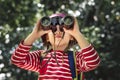 Little girl using binoculars in the forest Royalty Free Stock Photo