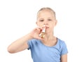 Little girl using nasal drops on white background. Allergy concept