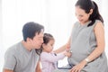 Little girl using stethoscope with her pregnant mother belly Royalty Free Stock Photo