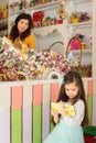 Little girl using tablet computer in candy store Royalty Free Stock Photo