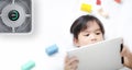 Little girl using tablet in room with modern air purifier