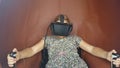 Little girl using a virtual reality glasses in cabine