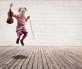 Little girl with violin jumping Royalty Free Stock Photo