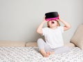 Little girl in virtual reality glasses at home
