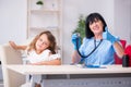 Little girl visiting old female doctor Royalty Free Stock Photo