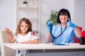 Little girl visiting old female doctor Royalty Free Stock Photo