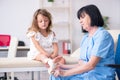 Little girl visiting old female doctor Royalty Free Stock Photo